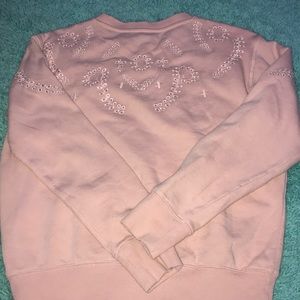a light pink sweater